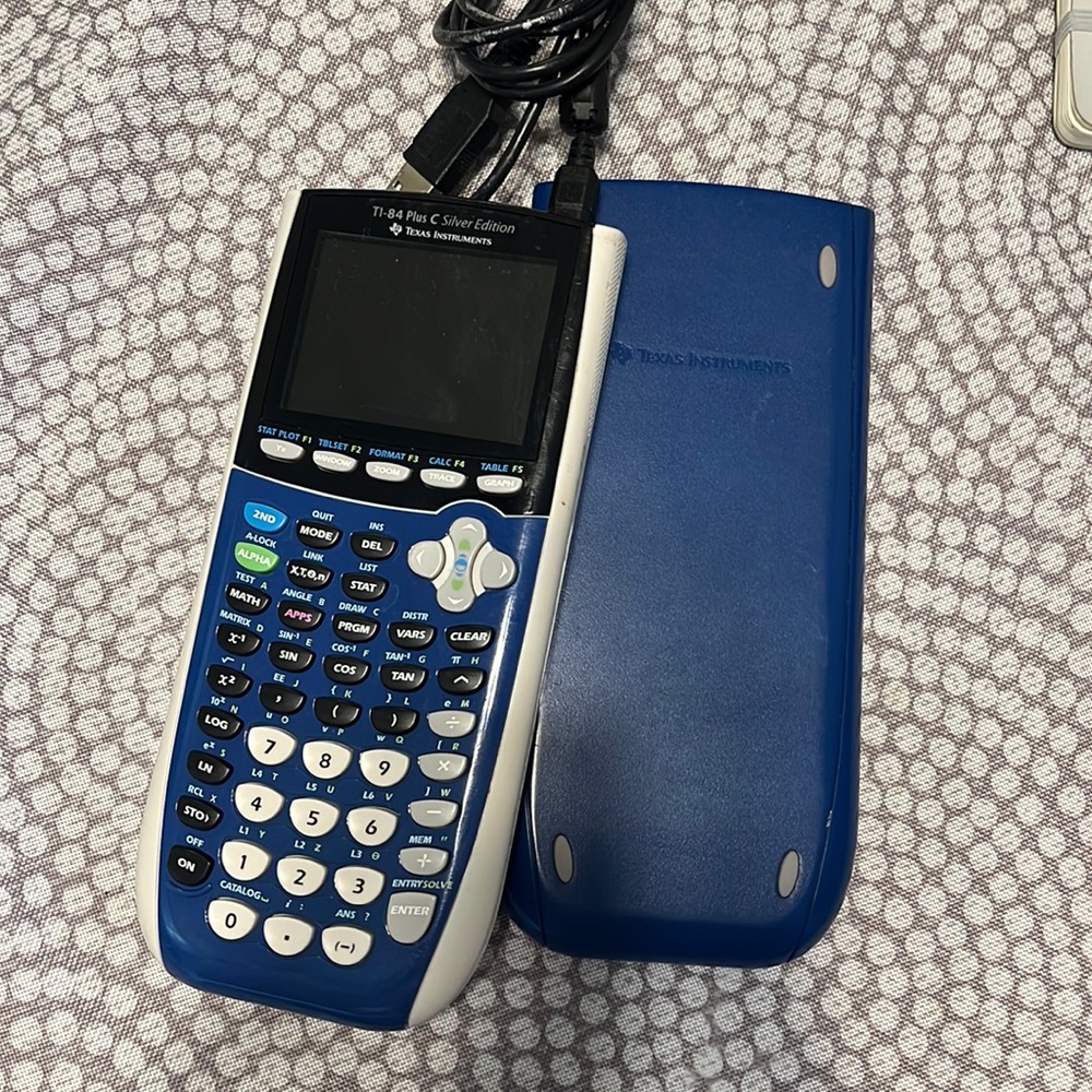 Texas Instruments TI-84 Plus Silver Edition Calculator and charging cord